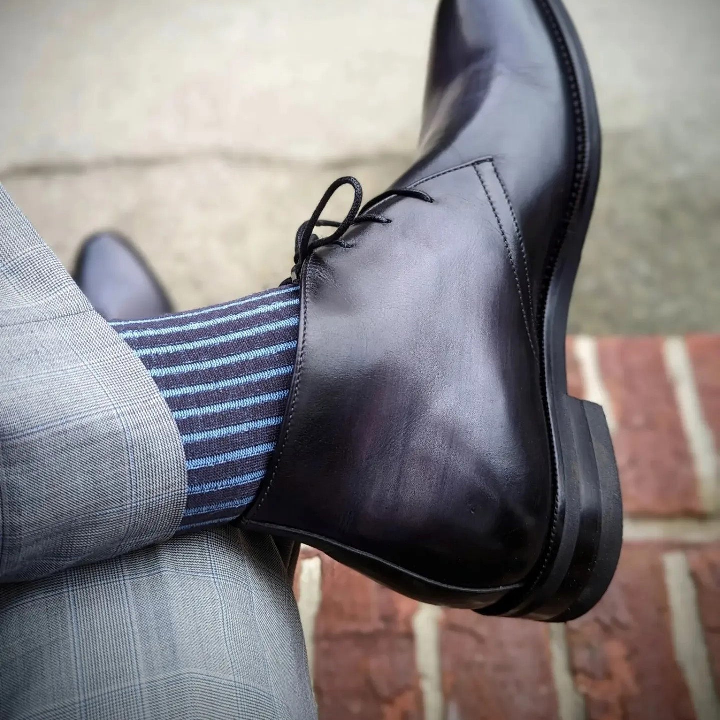 Michael Darren Shadow Stripe over the calf men's dress sock, Egyptian Cotton in Charcoal and Sky Blue, worn on foot with Michael Darren Chukka Boot in Smoke Grey Patina