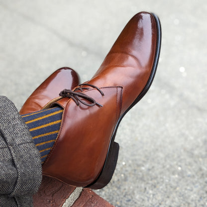 Michael Darren Shadow Stripe over the calf men's dress sock, Egyptian Cotton in Navy and Mustard, worn on foot with Michael Darren Chukka in Cognac Patina