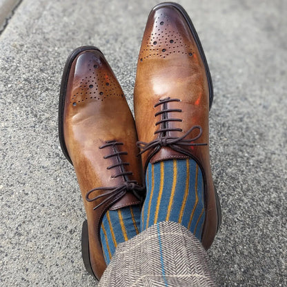 Michael Darren Shadow Stripe over the calf men's dress sock, Egyptian Cotton in Petroleum and Mustard, worn on foot with Michael Darren Medallion Toe Wholecut in Cuoio Patina